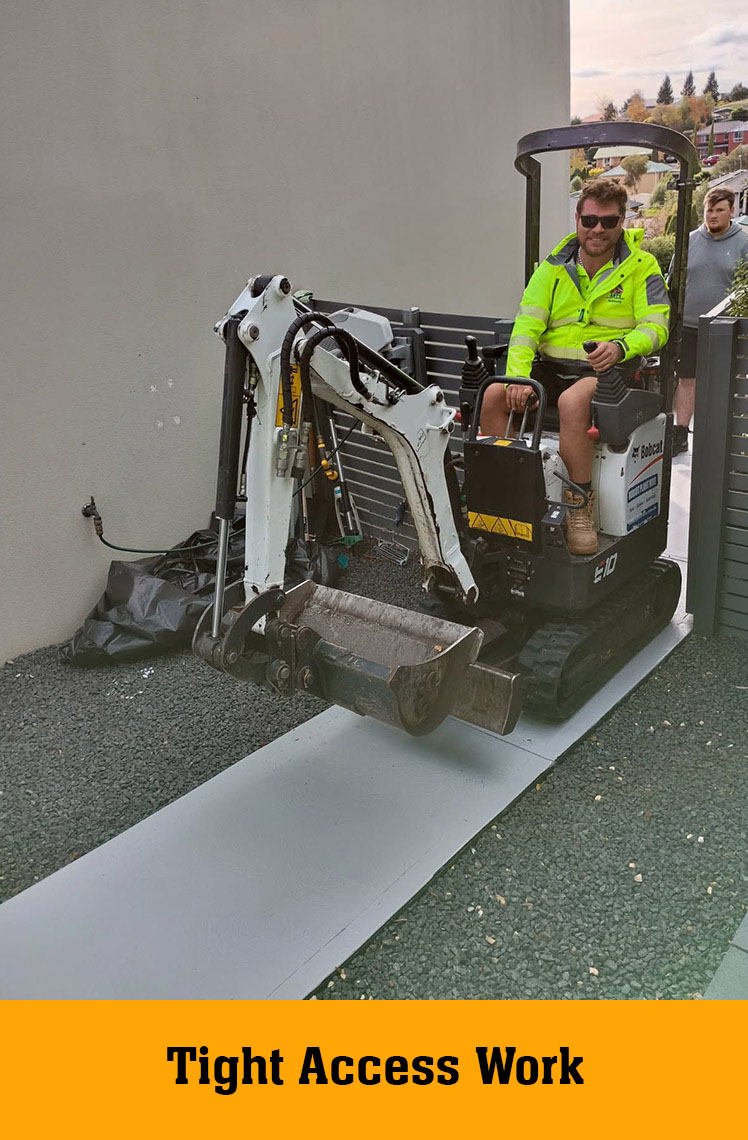 Man in hi-vis driving a mini excavator beside a house, labelled Tight Access Work