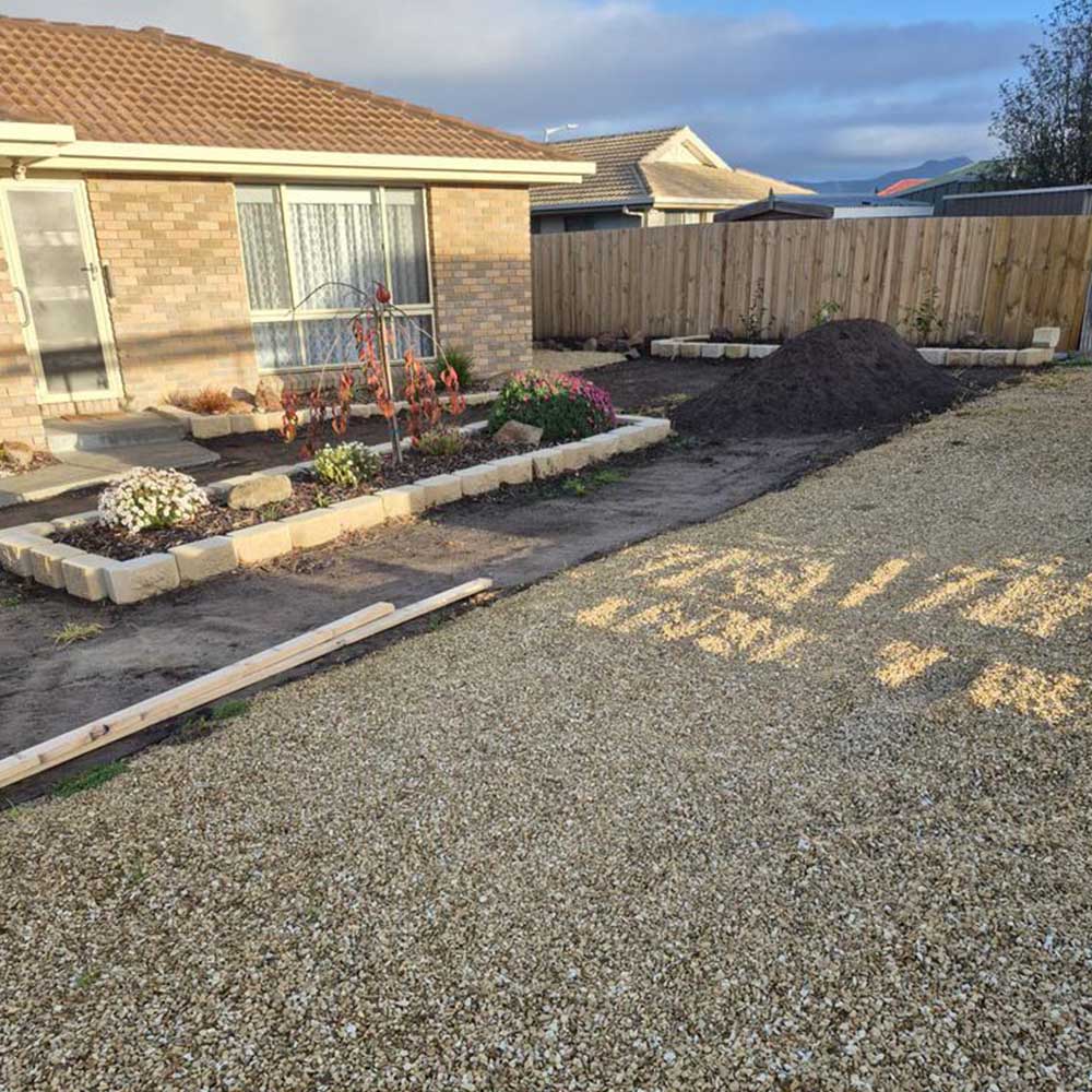 services8 Gravel yard and garden beds in front of a brick house