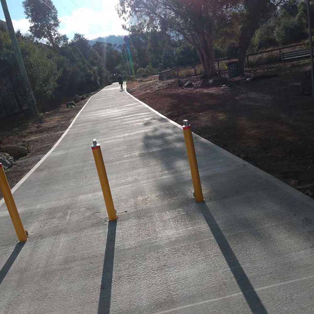 services9 New concrete path with yellow bollards through bushland